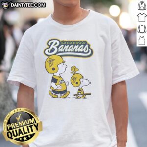 Original Peanuts characters and Savannah Bananas graphic t-shirt featuring colorful designs for fans of both franchises.