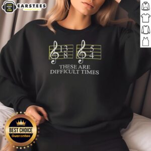 Cozy 'Good These Are Difficult Times' sweatshirt displayed on a wooden table, perfect for casual wear.