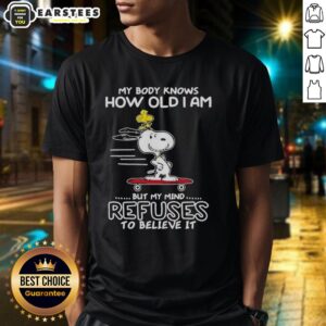 Good Snoopy Woodstock t-shirt design featuring 'My Body Knows How Old I Am But My Mind Refuses To Believe It' text.