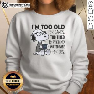 Good I'm Too Old For Games Snoopy sweatshirt featuring Snoopy looking tired, perfect for casual wear and fans of Peanuts.
