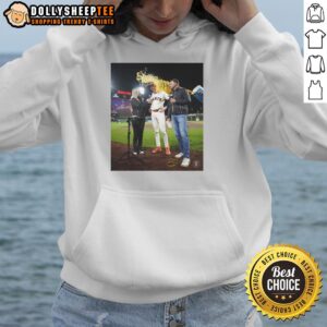 Daniel Susac in a San Francisco Giants hoodie as water is playfully thrown on someone during a game celebration.