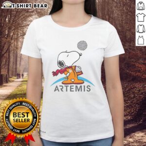 Ladies' tee featuring a cute Snoopy as an astronaut, perfect for fans of space and Peanuts. Nice Snoopy Artemis design.
