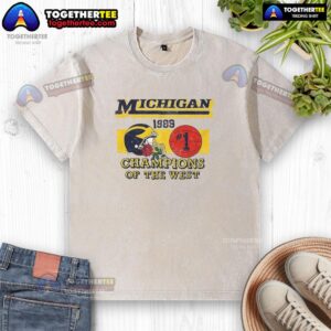 Alt Text: Vintage washed t-shirt featuring the Michigan Wolverines NCAA 1989 Champions of the West graphic design.
