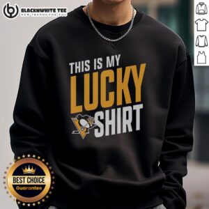 Alt Text: Person wearing a lucky Pittsburgh Penguins sweatshirt at a game, showcasing team spirit and enthusiasm.