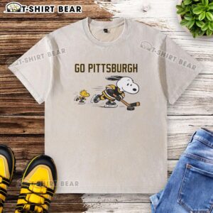 Cheerful Snoopy and Woodstock in Pittsburgh Penguins washed t-shirt, showing support for the team.