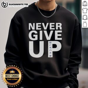 Alt Text: Mohamed Salah wearing a Never Give Up sweatshirt, showcasing his determination and style on the field.