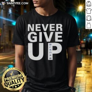 Alt Text: Mohamed Salah wearing a Never Give Up T-shirt, showcasing his determination and positive attitude on the field.