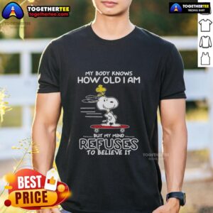 Top Snoopy Woodstock T-Shirt: 'My Body Knows How Old I Am But My Mind Refuses To Believe It' design for fun, casual wear.