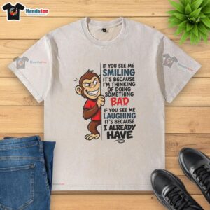 Nice monkey graphic on a washed t-shirt, smiling with a mischievous expression, perfect for playful fashion enthusiasts.