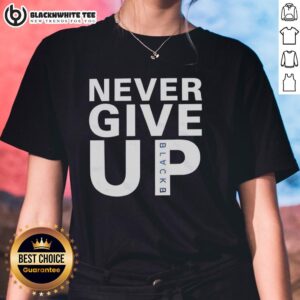 Mohamed Salah wearing a 'Never Give Up' ladies tee, showcasing style and determination on the field.
