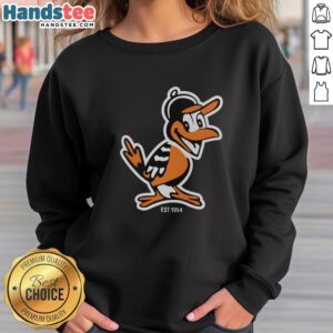 Nice Zay wearing Baltimore Orioles mascot sweatshirt, celebrating the team's legacy since 1954 with vibrant flowers.