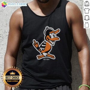 Hot Zay wearing Baltimore Orioles mascot tank top, celebrating team spirit since 1954 at a lively outdoor event.