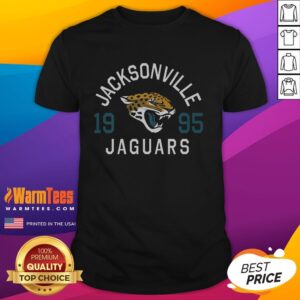 Alt Text: Awesome Jacksonville Jaguars Heritage Print T-Shirt featuring bold team logo and vintage design for fans.