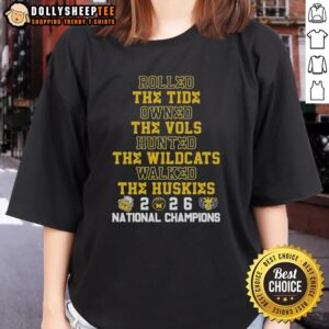 2026 Michigan Wolverines ladies tee featuring bold graphics celebrating victories over rivals like Tide, Vols, Wildcats, and Huskies.
