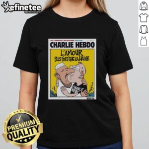 Alt Text: Official Charlie Hebdo tee featuring two men kissing, symbolizing 'L'Amour Plus Fort Que La Haine' message of love.