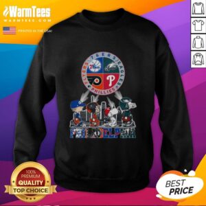 Alt Text: Cozy sweatshirt featuring Snoopy with Philadelphia sports teams: 76ers, Eagles, Flyers, and Phillies logos.