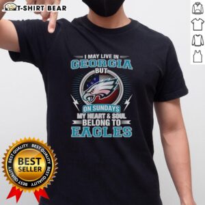 Official Philadelphia Eagles t-shirt featuring 'I May Live In Georgia But My Heart Belongs To Eagles' slogan.