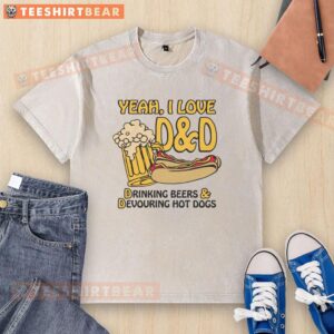 Group of friends laughing while drinking beers and devouring hot dogs in washed t-shirts at a backyard BBQ party.