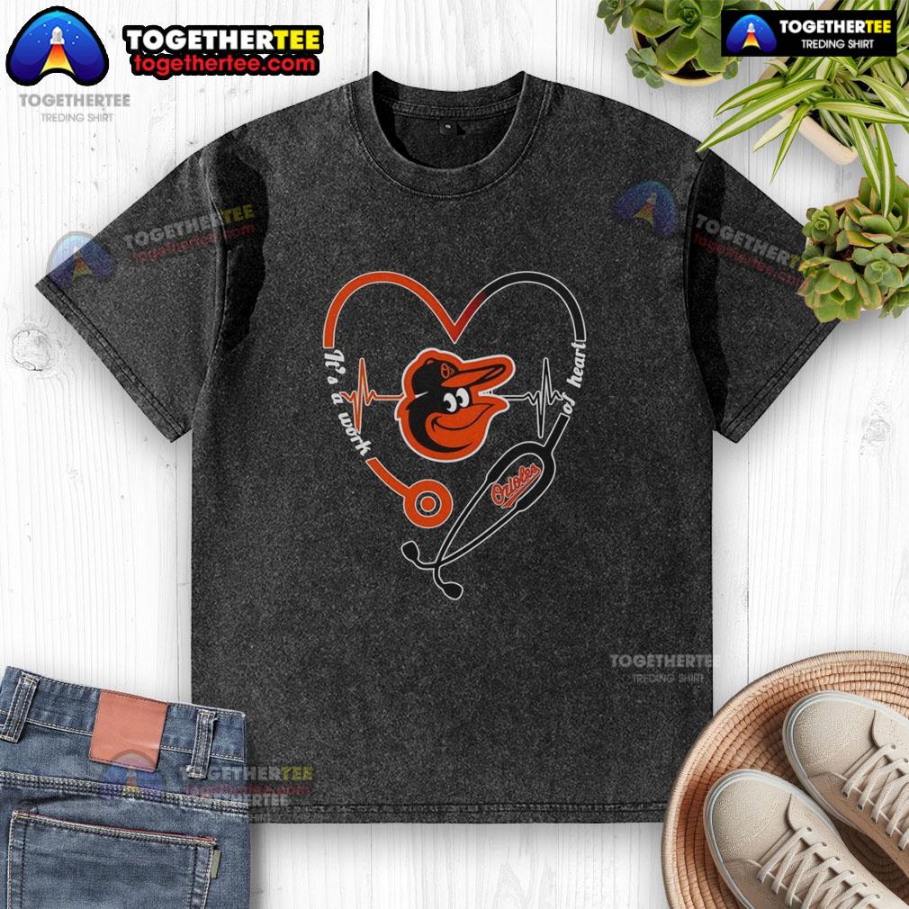 Awesome Baltimore Orioles It's A Work Of Heart Stethoscope And Heartbeat Shape Washed T-Shirt Baltimore Orioles 'It's A Work Of Heart' stethoscope and heartbeat shape graphic on a washed T-shirt.