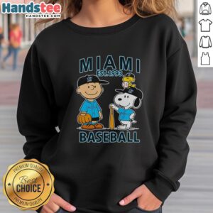 Good Charlie Brown, Snoopy, and Woodstock wearing Miami Marlins jersey on a cozy sweatshirt, Est. 1993.