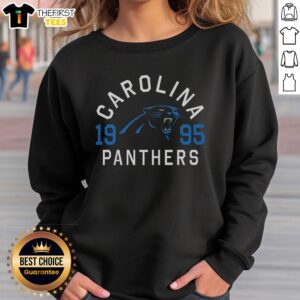 Alt Text: Official Carolina Panthers Heritage Print Sweatshirt featuring team colors and logo, perfect for fans and casual wear.