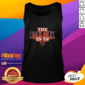 Chicago Bears fan wearing a tank top celebrates after a good draft pick announcement at a football event.