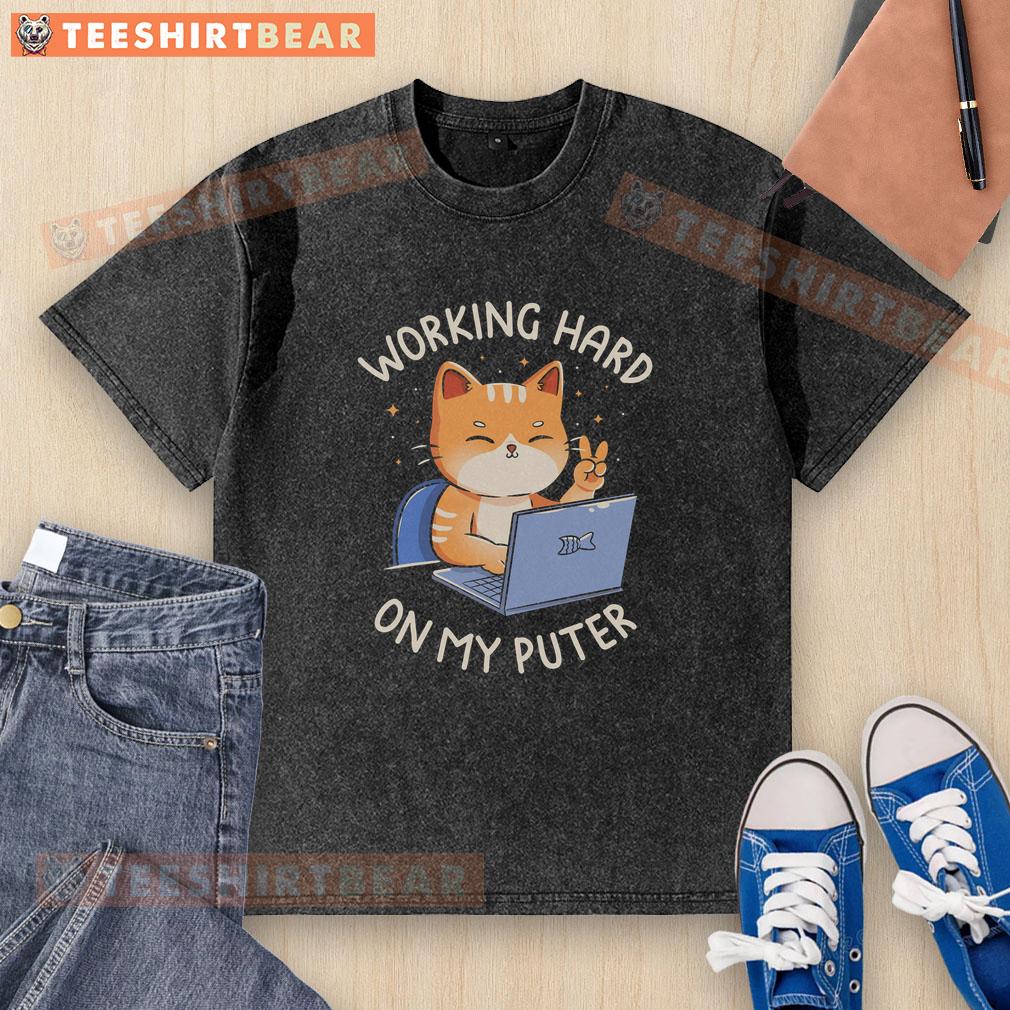 good-working-hard-on-my-puter-washed-t-shirt Person wearing a 'Good Working Hard On My Computer' washed t-shirt while focused on laptop, showcasing work-from-home vibes.