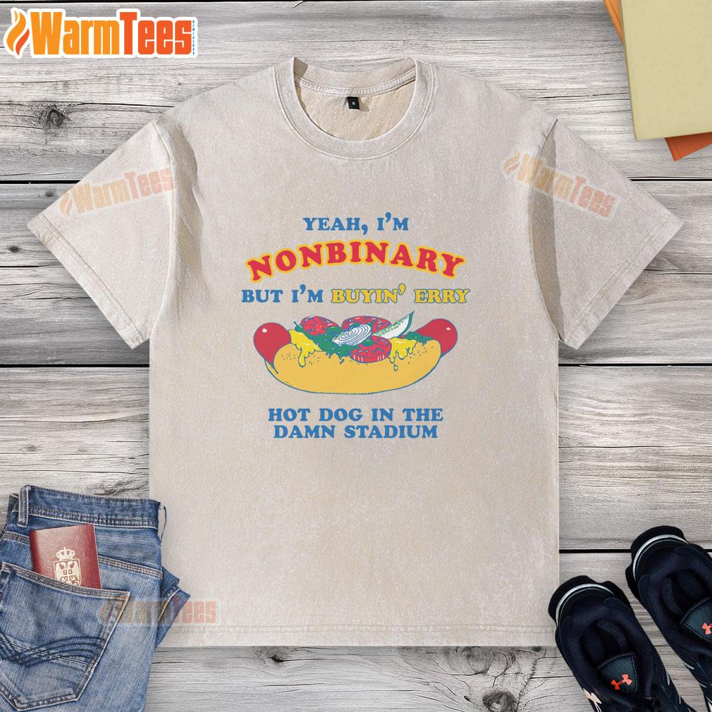 good-yeah-im-nonbinary-but-im-buyin-erry-hot-dog-in-the-stadium-washed-t-shirt Nonbinary person proudly wearing a 'Good Yeah I'm Nonbinary' washed t-shirt while enjoying hot dogs at a stadium.