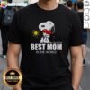 Hot Snoopy hugging a heart on a 'Best Mom In The World' T-shirt, perfect gift for moms who love Peanuts characters.