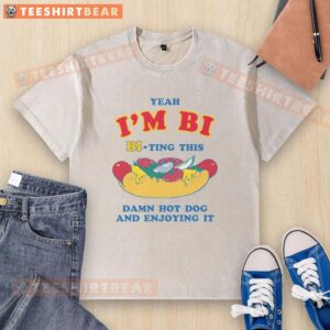 Alt Text: Person in a washed t-shirt enjoying a hot dog with a funny expression, showcasing the 'Funny Yeah, I'm Bi' theme.