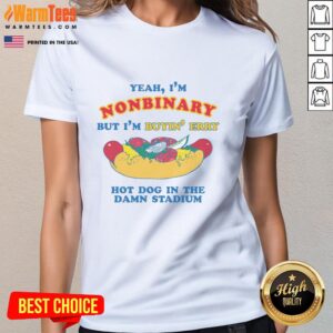 Nonbinary person wearing a 'Good Yeah I'm Nonbinary But I'm Buyin' Erry Hot Dog In The Stadium' tee at a stadium.