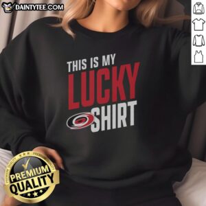 Person wearing a Carolina Hurricanes sweatshirt, showcasing team spirit for game day and good luck.