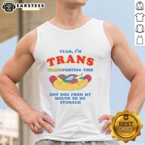 Person wearing 'Funny Yeah I'm Trans' tank top, humorously transporting a hot dog from mouth to stomach.