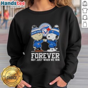 Charlie Brown fist pump in Toronto Blue Jays sweatshirt, celebrating fandom with Snoopy. Cute sports apparel for fans.