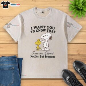 Alt Text: Cute Snoopy graphic on a washed t-shirt with the message 'Someone cares, not me, but someone' for casual wear.