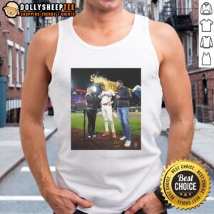 Alt Text: Daniel Susac of the San Francisco Giants wearing a tank top, water splashing on a fan during a game celebration.