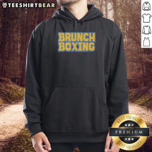 Trendy Top Brunch Boxing Hoodie displayed on a wooden table, perfect for stylish brunch outings and fitness enthusiasts.