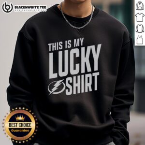 Fan wearing a Tampa Bay Lightning sweatshirt, showcasing team spirit and luck at a hockey game.