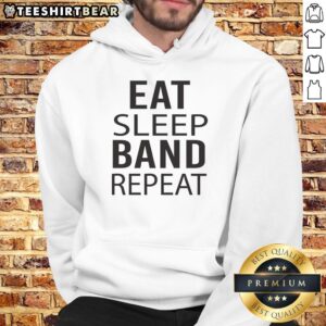 Alt Text: Musician wearing a 'Eat Sleep Repeat' hoodie while marching with a band, showcasing vibrant performance energy.