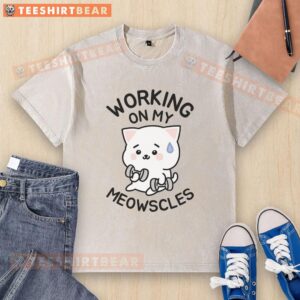 Person wearing a washed T-shirt featuring Meowscles design, showcasing a stylish and casual look.