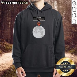 Person wearing an 'Awesome Moon Location Review' funny hoodie while standing under a starry night sky.