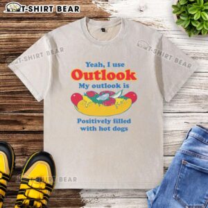 Funny graphic of a T-shirt reading 'My Outlook is Positively Filled with Hot Dogs' with a playful design.