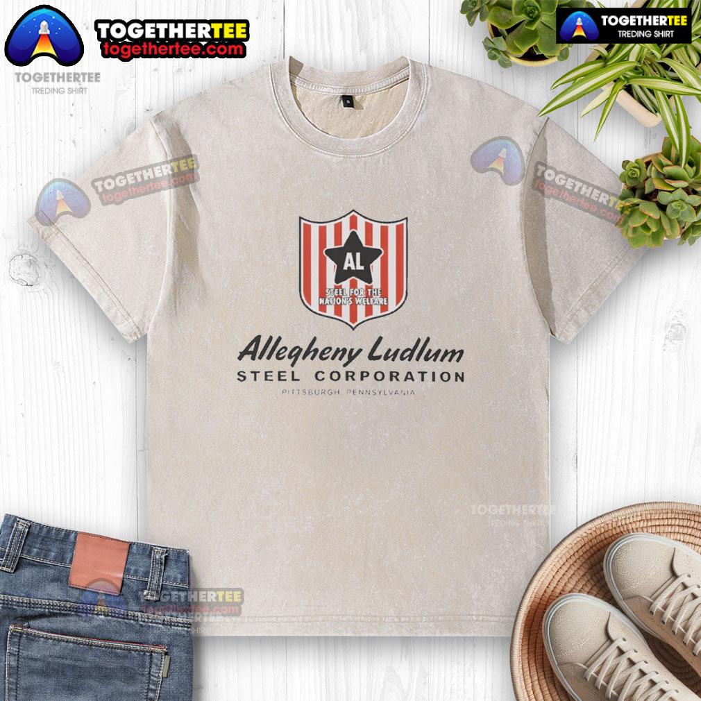 Nice Allegheny Ludlum Steel Corporation Pittsburgh Pennsylvania Al Badge Washed T-Shirt Nice Allegheny Ludlum Steel Corporation Pittsburgh Pennsylvania Al badge washed t-shirt displayed on a wooden background.