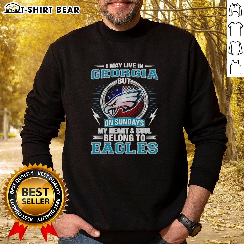 Official Philadelphia Eagles I May Live In Georgia But On Sundays My Heart And Soul Belong To Eagles Sweatshirt Alt Text: Official Philadelphia Eagles sweatshirt with I May Live in Georgia, But My Heart Belongs to Eagles slogan.
