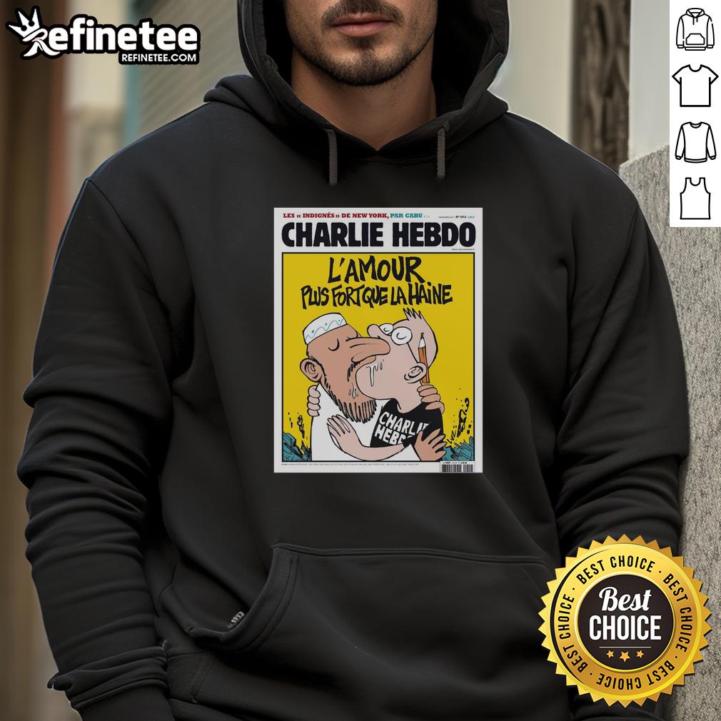 official-two-men-kissing-charlie-hebdo-lamour-plus-fort-que-la-haine-hoodie Two men kissing while wearing the 'Charlie Hebdo L'Amour Plus Fort Que La Haine' hoodie, symbolizing love and unity.