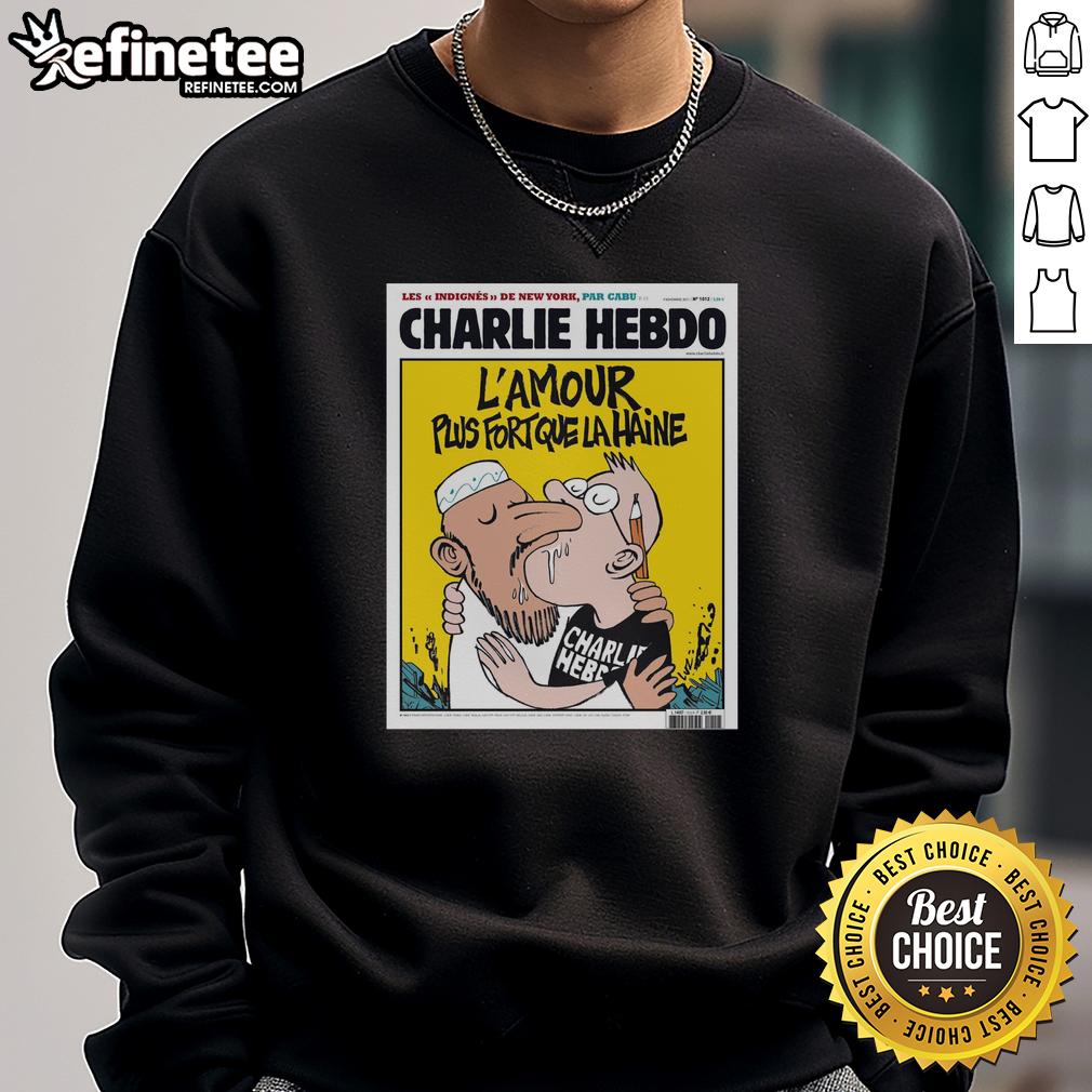 official-two-men-kissing-charlie-hebdo-lamour-plus-fort-que-la-haine-sweatshirt Alt Text: Two men kissing in a vibrant 'L'Amour Plus Fort Que La Haine' sweatshirt, symbolizing love and unity, Charlie Hebdo style.