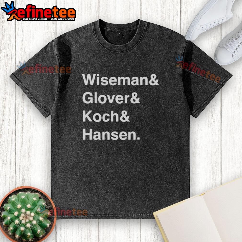 official-wiseman-glover-koch-hansen-washed-t-shirt Alt Text: Official Wiseman Glover Koch Hansen washed t-shirt displayed on a wooden table, featuring a relaxed fit and soft fabric.