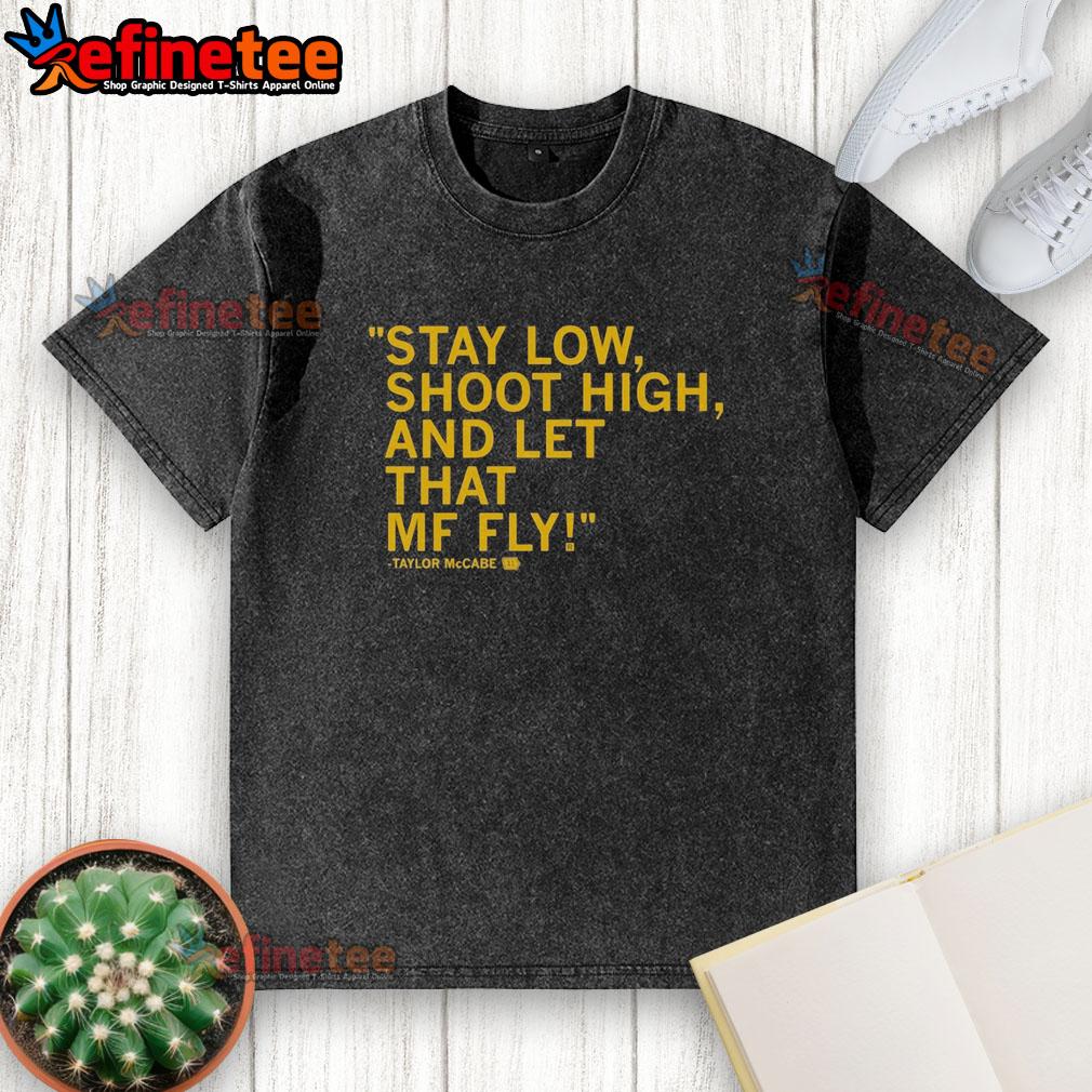 original-taylor-mccabe-stay-low-shoot-high-and-let-that-mf-fly-washed-t-shirt Original Taylor McCabe Stay Low Shoot High and Let That MF Fly washed t-shirt displayed on a wooden background.