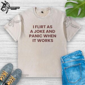 Funny quote on a washed t-shirt: 'I flirt as a joke and panic when it works' - perfect for casual wear.