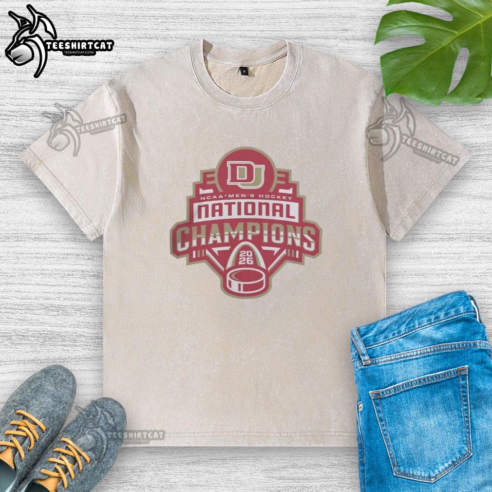 premium-denver-pioneers-ncaa-hockey-champions-2026-washed-t-shirt Premium Denver Pioneers NCAA Hockey Champions 2026 washed t-shirt featuring team logo and vintage design.